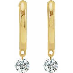Gold earrings with clear gemstones on a white background