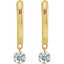 Gold earrings with clear gemstones on a white background