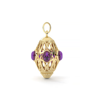 Gold pendant with purple gemstones on a white background