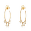 A gold hoop earring with four lucky charms on each earring. Diamond encrusted heart, star, eye, and key are dangling on the bottom of the hoop. 