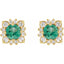 Gold earrings with green gemstones and clear stones on a white background