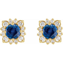 Pair of gold earrings with blue gemstones on a white background
