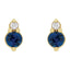 Gold earrings with blue gemstones and clear stones on a white background