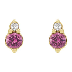 Gold earrings with pink gemstones on a white background