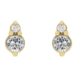 Gold earrings with clear gemstones on a white background