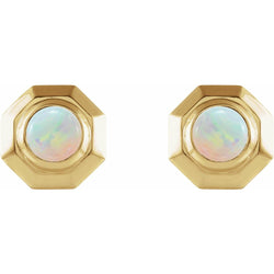 Gold hexagonal earrings with opal stones on a white background