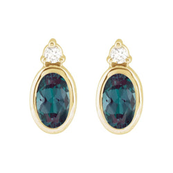 Gold earrings with blue gemstones on a white background