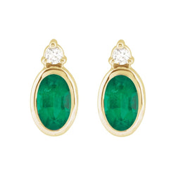 Gold earrings with green gemstones on a white background