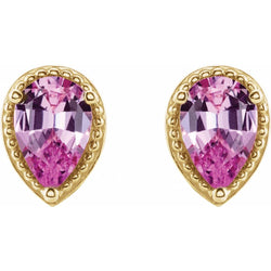 Gold earrings with pink teardrop-shaped gemstones on a white background