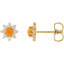 Gold earrings with orange center and diamond-like stones on a white background