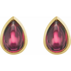 Gold earrings with teardrop-shaped red gemstones on a white background