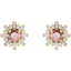Pair of earrings with pink gemstones and gold and diamond accents on a white background