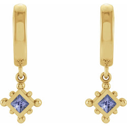 Gold earrings with purple gemstones on a white background