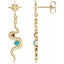 Gold snake-shaped earrings with gemstones on a white background