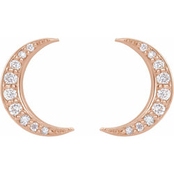 Rose gold crescent moon earrings with clear gemstones on a white background