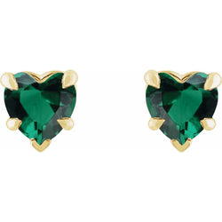Heart-shaped green gemstone earrings with gold accents on a white background