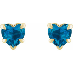 Heart-shaped blue gemstone earrings with gold setting on a white background