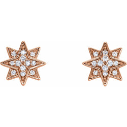 Rose gold star-shaped earrings with clear gemstones on a white background