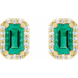 Gold earrings with emerald green gemstones and small diamonds on a white background