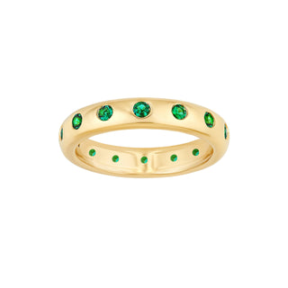 A emerald eternity band made in 14k yellow gold with round emeralds set around the ring. 