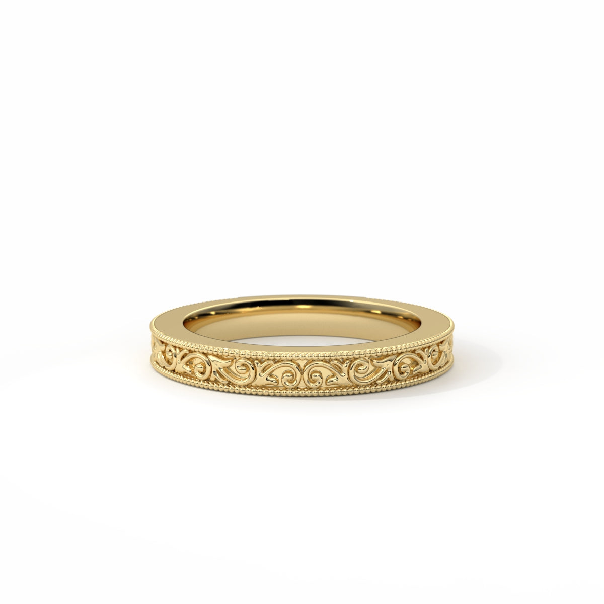 Gold ring with intricate design on a white background