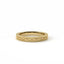 Gold ring with intricate design on a white background