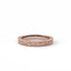 Rose gold ring with intricate design on a white background