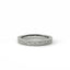 Set of three silver rings with embedded diamonds on a light gray background