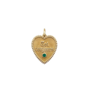 A solid gold heart pendant with beaded border. Old English Font " Toi Toujours" and a diamond in the center. Overall a vintage feeling.