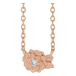 Rose gold flower-shaped necklace with a diamond on a white background