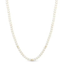 Round white fresh water pearls with gold beaded accents and a round clasp.
