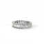 Elegant diamond ring with emerald-cut and round diamonds on a white background