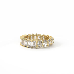 Gold ring with emerald-cut and round diamonds on a white background