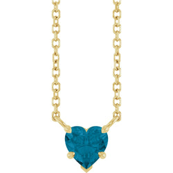 Gold necklace with a heart-shaped blue gemstone on a white background