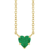 Gold necklace with a heart-shaped green gemstone on a white background