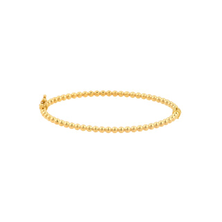 A gold bangle bracelet with beaded gold designs. This Bracelet is oval shape with a  hinge and closure. 