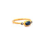 Product picture showing a blue sapphire ring with bezel setting and two diamonds on the sides. This gold ring has a hammered antique look. 