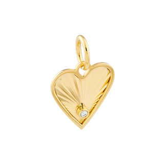 A solid gold fluted heart charm with a diamond. This charm has a fluted design that reflects light.  