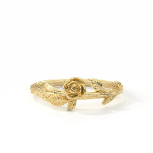 Gold ring with a rose design on a white background