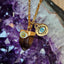 A solid gold round disc Evil eye charm with enamel design. blue enamel colored eye with black almond eye shape and diamonds. 