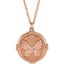 A gold round coin pendant with a butterfly center with detailed wings  and decorated frame on a chain.