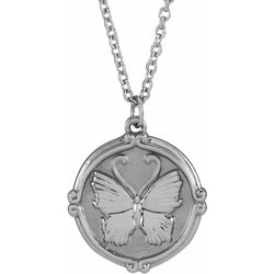A gold round coin pendant with a butterfly center with detailed wings  and decorated frame on a chain.