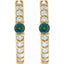 Gold earrings with green gemstones and clear stones on a white background