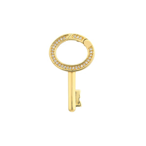 A solid gold push lock connector that is shaped like a key. With the lock positioned at the top ring part of the key with pave diamond set around the ring. 