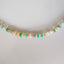 A rainbow colored opal strand beaded necklace made with gold filled wheel clasp. 