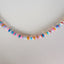 A rainbow colored opal strand beaded necklace made with gold filled wheel clasp. 