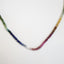 A round beaded smooth beaded rainbow tourmaline hand knotted with matching rainbow colored silk string. 
