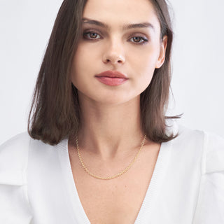 A 3mm gold cable necklace chain, the perfect size, in yellow gold with small oval links. This chain has a lobster clasp closure. Shown in model.