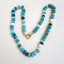A large turquoise blue beaded necklace with pearls hand knotted with crystals for a mixed look. Finished with solid gold findings and gold clasp. 
