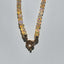 A high quality hand knotted Ethiopian white opal with silk threads and gold beaded accents and wheel clasp. 